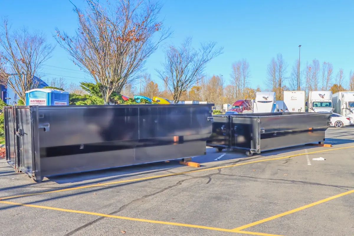 Professional dumpster rental service with roll-off container on residential driveway in Wareham